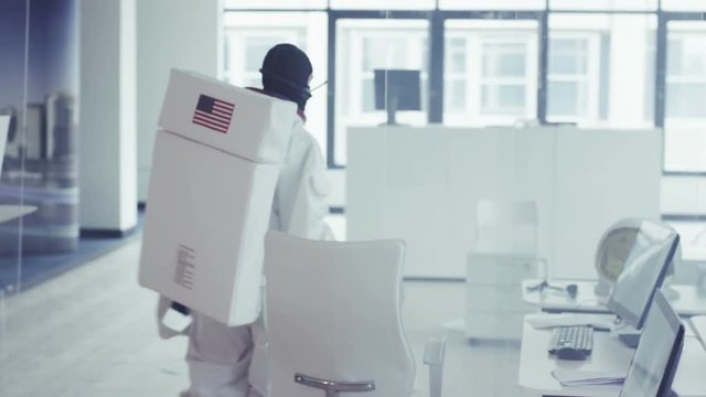  Funny astronaut in room full of computers dancing enthusiastically
