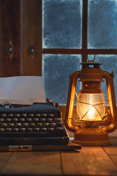 Vintage typewriter under oil lamp light