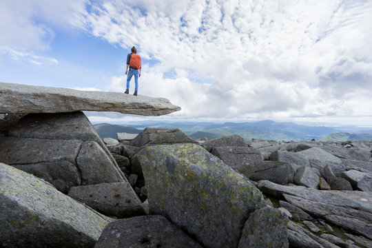 Female hiker in rugged mountains.