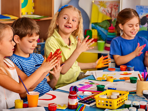 Small students with teacher finger painting in art school class. Break school in painting class. Mom and kids at home. Craft drawing education develops creative abilities of children. Children indulge