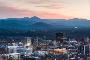 View of Asheville city skyline and mountains after sunset