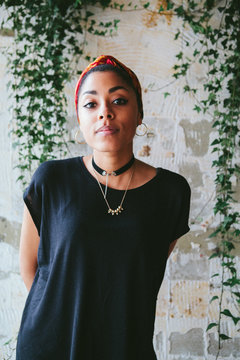 Portrait of a beautiful young mixed race woman framed by Ivy