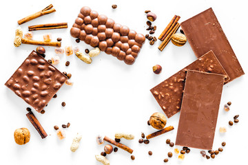 Chocolate bars on white background top view copyspace