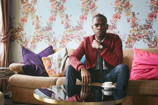 Indoor Portrait of Stylish Young Black Man in Bright Living Room