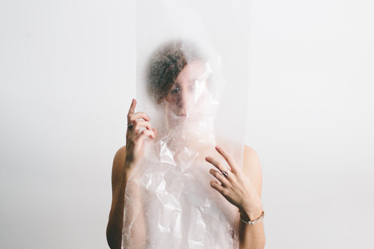 Woman looking through plastic
