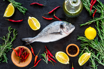 Cooking dorado fish. Black background top view