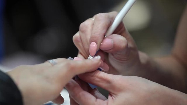 Female hands manicure, nail polish in beauty studio