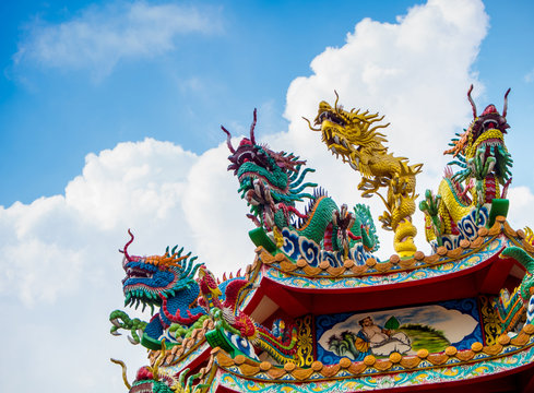 Colorful chinese dragon and swan sculpture on the rooftops of chinese temple