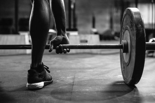 Rear view of man about to lift barbell