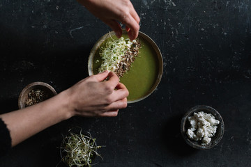 Bean soup with seeds, bean sprouts and ricotta