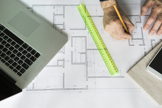 architect is working with blueprints