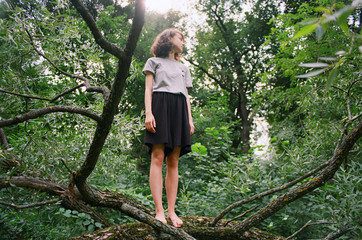 Young woman standing on a tree