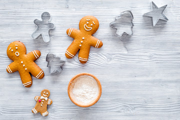 Make gingerbread cookie for new year 2018. Gingerbread man and flour on grey wooden background top view copyspace