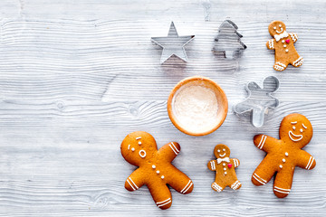 Make gingerbread cookie for new year 2018. Gingerbread man and flour on grey wooden background top...