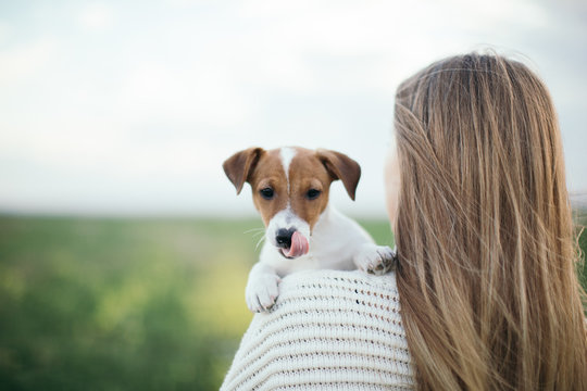 Woman enjoying nature with a Jack Russell puppy