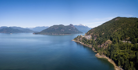 Naklejka na ściany i meble Aerial Panoramic Landscape view of Howe Sound and Sea to Sky Highway. Taken North of Vancouver, British Columbia, Canada, during a sunny summer day.