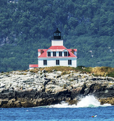 Fototapeta na wymiar Egg Rock Lighthouse with water splashing on it's shore
