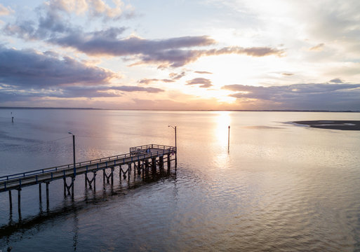 Aerial view on the wooden quay on Pacific Ocean. Picture taken in White Rock, Greater Vancouver, BC, Canada, during a cloudy sunset.