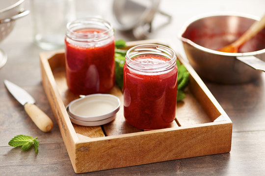 Cans of jam in wooden tray