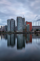 Beautiful view of False Creek with Downtown Vancouver, BC, Canada, in the Background. Picture taken during a cloudy sunrise.
