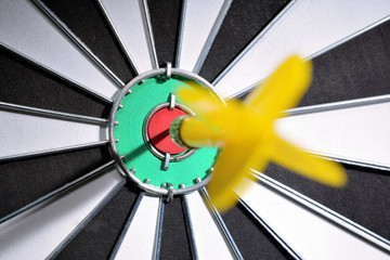 Dartboard with dart arrow hitting the center of the target. Marketing concept.
