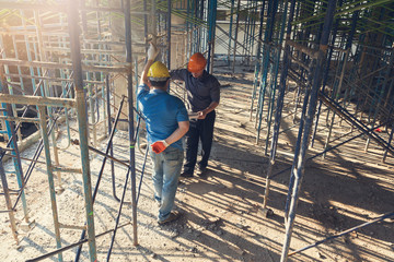 Construction concepts, Engineer and Architect working at Construction Site with blueprint, Vintage Effect