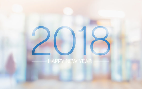 Happy new year 2018 word on blur pale color convention hall office building bokeh background.
