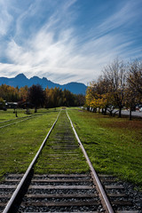 Railroad tracks leading to mountains