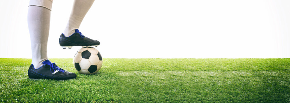 Man controls a soccer ball on the grass