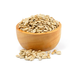 sunflower seeds in a wooden bowl on a white background