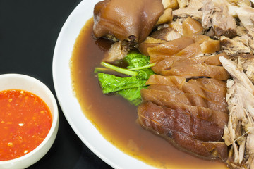 Stewed pork leg on dining table.With spicy sauce