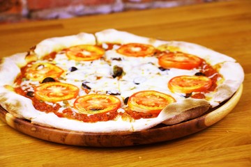 Vegetarian pizza in wooden tray