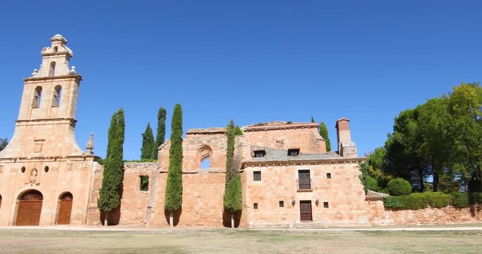4k video. Landmark of facade, bell tower and door of ancient convent of San Francisco de Asis, from thirteenth century, in old town of Ayllon village, in Segovia, Spain, Europe
