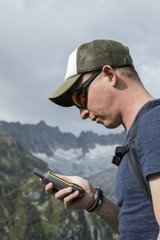 Alpinist is oriented with a GPS device in the terrain