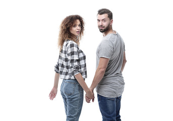 Rear view of happy couple holding hands and looking at camera