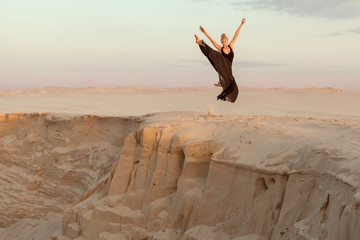 Woman jumped over the abyss in the dance, she shows the performance. © Petro