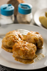 Flat lay above served meal with sarma cooked potatoes salt pepper and bread