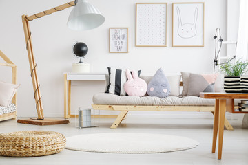 Designed lamp near beige sofa