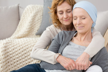 Woman comforting friend with cancer