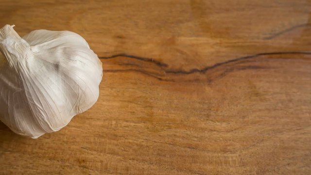 The garlic on wood Table in kitchen close up image