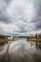 Fototapeta premium View of the Charles Bridge in Prague, Czech Republic. Cloudy gray sky