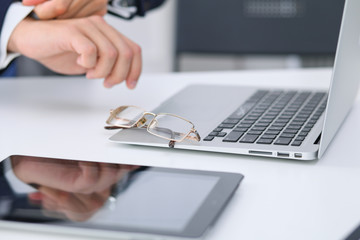 Businessman working by typing on laptop computer. Man's hands on notebook or business person at workplace. Employment  or start-up concept