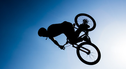 bmx rider performing stunts in the air