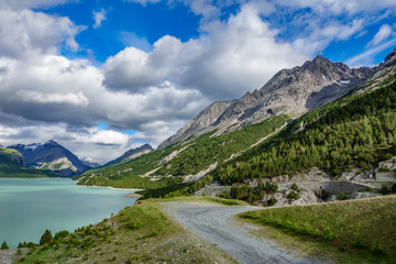 Obraz premium Lake of Cancano, track and mountains Bormio (Province of Sondrio)