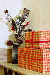 New Year's decorations in the interior. Gift boxes in red checkered wrapping paper