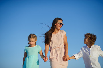 Young mother holding her son and daughter.