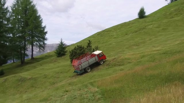 tractor goes up the meadows of the armentara