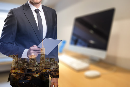 businessman with tablet with blurry office