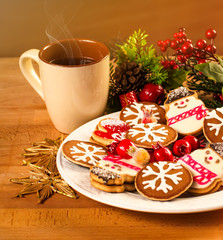 Mug with hot drink and Christmas cookies. Background with cup of chocolate, tea or coffee, festive decoration. Winter holiday concept. Beautiful cookies and bakery with cup of steaming beverage.