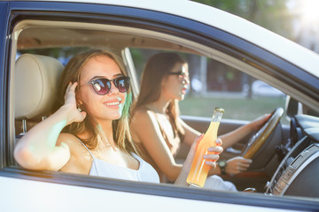 The young women in the car smiling